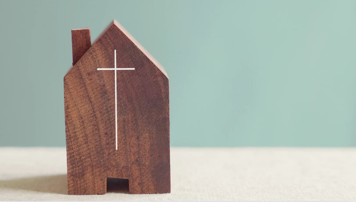 Brown church with cross on teal background