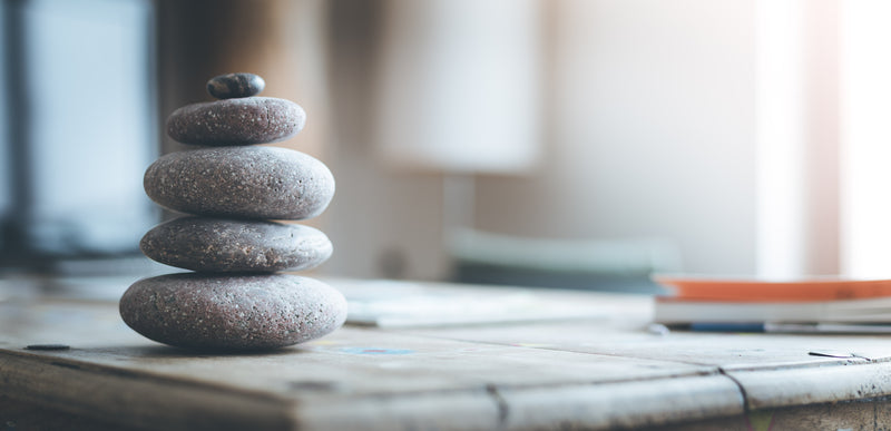 Stacked gray rocks on table in room