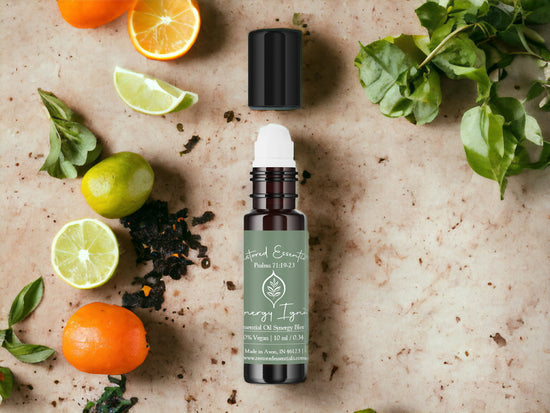 Essential oils lime, oranges, black pepper, on table with green plant