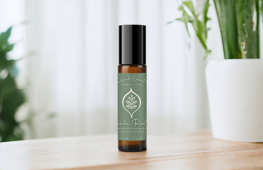 Muscle soothing oil blend on table with plants in background