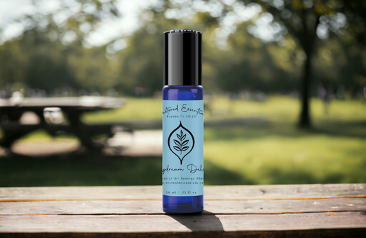 Blue essential oil bottle on picnic table